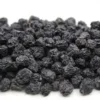 Close-up of plump, dark purple dries aronia berries